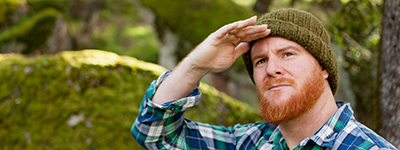 Red haired looks for something in the forest